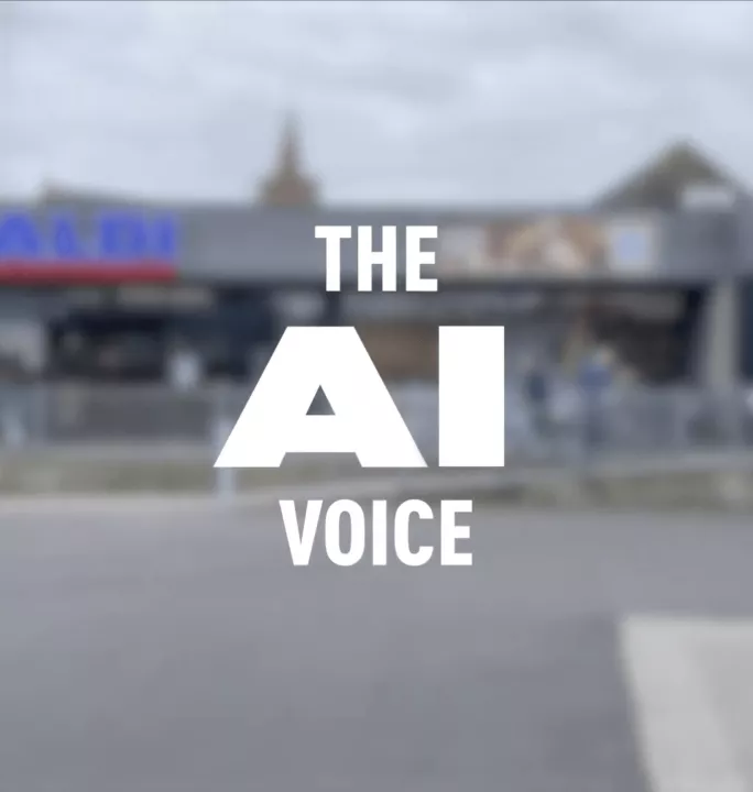 Cover image of a blurred Aldi store exterior with bold white text overlay reading "THE AI VOICE" as part of an artificial intelligence case study.