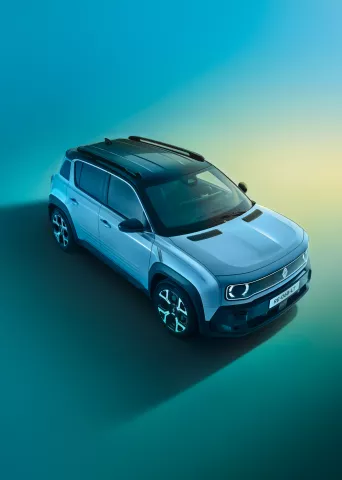 Aerial view of a modern white Renault compact SUV against a smooth blue-gradient background, showcasing the vehicle's contemporary design and stylish roof rails.