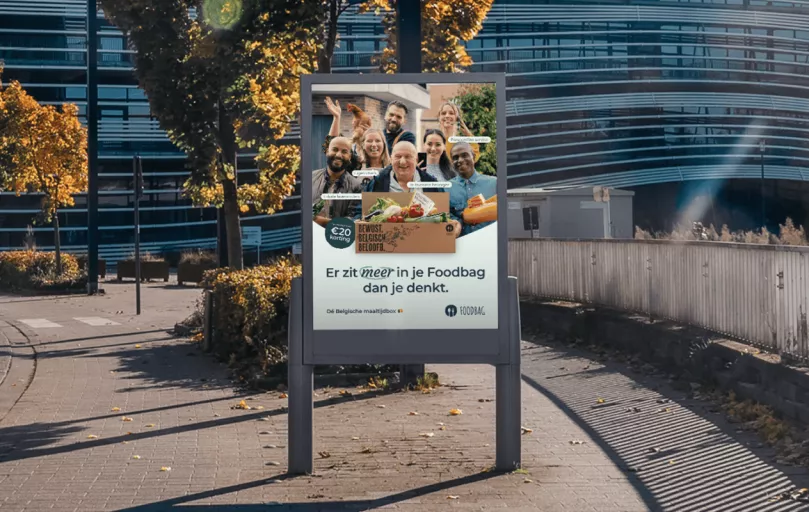 Outdoor advertisement for Foodbag featuring smiling grocers, farmers, growers etc. Headline reads ‘There's more in a Foodbag than meets the eye’.