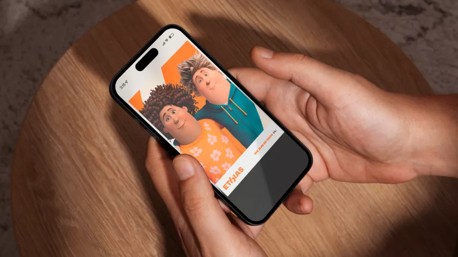 Springbok Agency campaign visual mock-up for Ethias, featuring a hand holding a smartphone that displays an Ethias social media ad with animated characters, illustrating a seamless mobile-first customer experience.